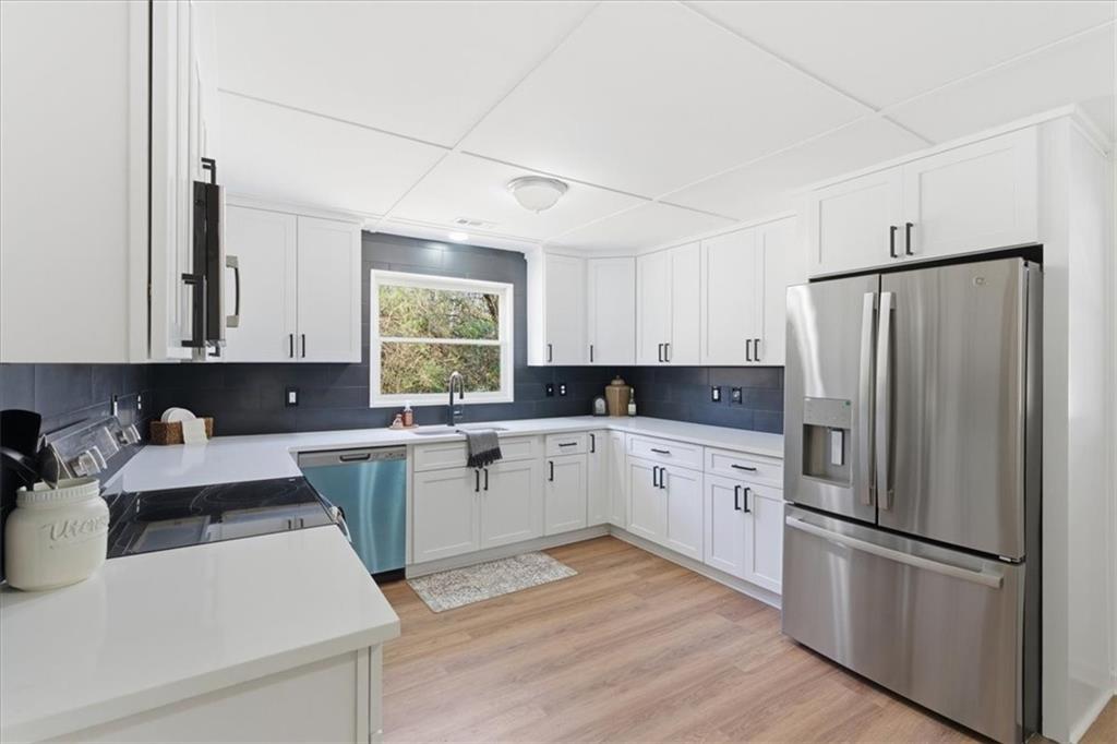 344 Colbert Road Dallas, GA 30132 - Photo 8 of 29 a kitchen with a refrigerator and white cabinets