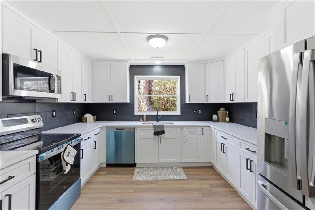344 Colbert Road Dallas, GA 30132 - Photo 9 of 29 a kitchen with a white cabinets and window