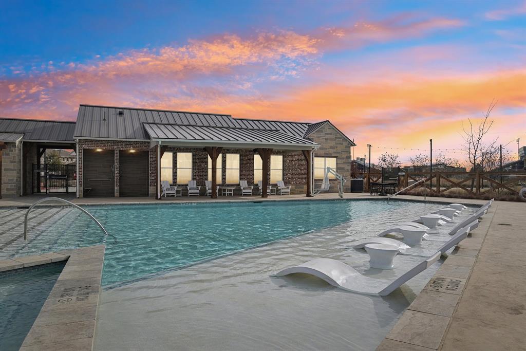 4430 Prairie Crossing Prosper, TX 75078 - Photo 2 of 15 The property features a swimming pool with submerged lounge seating