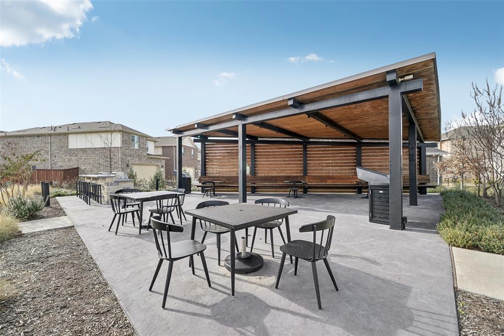 4430 Prairie Crossing Prosper, TX 75078 - Photo 6 of 15 Outdoor common area featuring a covered patio structure with a slatted wood ceiling, a barbecue grill, and concrete paving