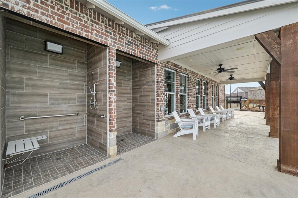4430 Prairie Crossing Prosper, TX 75078 - Photo 8 of 15 The property features an outdoor shower area with tiled walls and flooring, a mounted shower head, and a foldable bench
