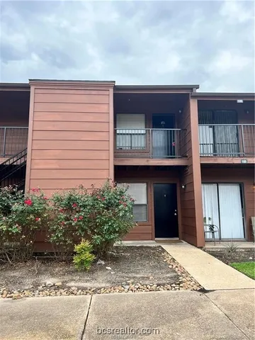 a view of a brick house with a large windows
