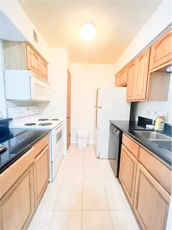a kitchen with stainless steel appliances a sink stove and cabinets