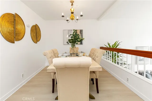 a view of a dining room with furniture and a chandelier