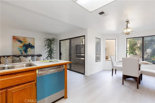 a view of a kitchen with a sink and a refrigerator