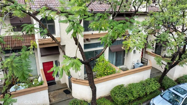 front view of a house with a tree