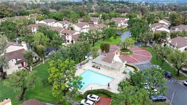 an aerial view of a house with a yard and lake view