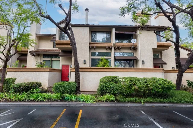 a front view of a house with a yard garage and outdoor seating