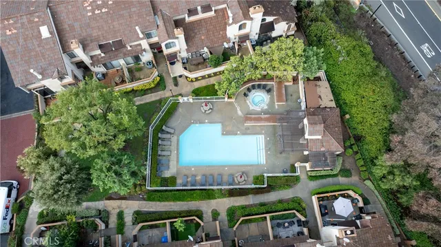 an aerial view of a house with garden space and street view