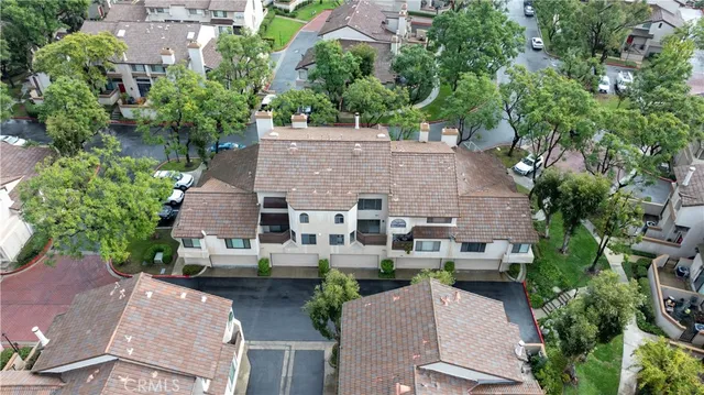 an aerial view of multiple houses with yard