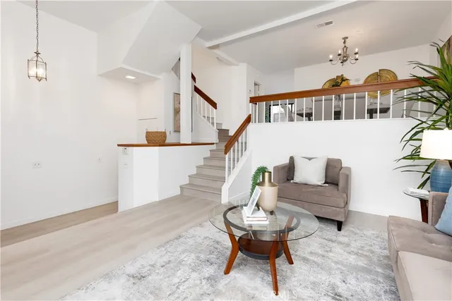 a living room with furniture and a chandelier