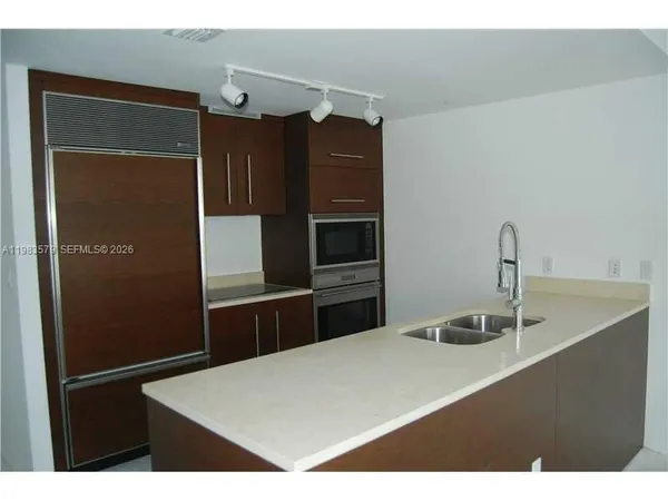 a kitchen with a refrigerator and a sink