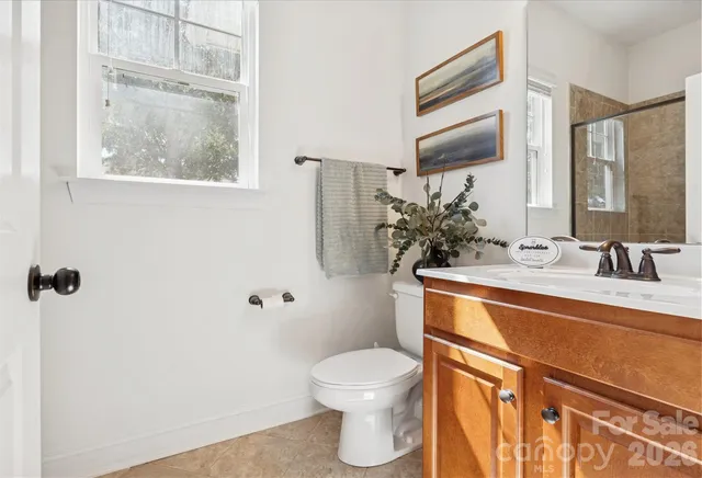 a bathroom with a granite countertop tub sink and mirror