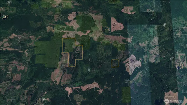 an aerial view of a house with garden space and street view