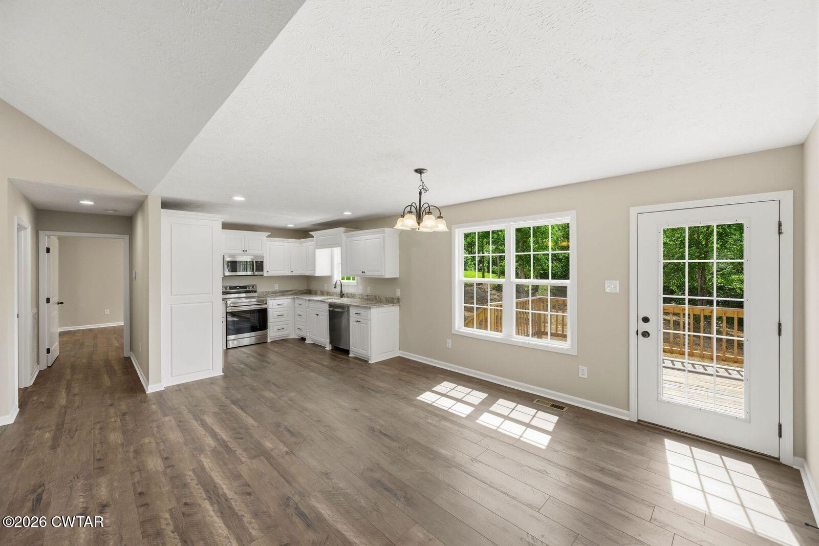 435 Old Huntingdon Road Lexington, TN 38351 - Photo 26 of 26 a view of a kitchen with wooden floor and a ceiling fan