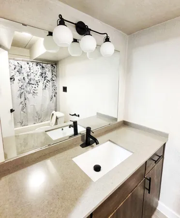 a bathroom with a sink and a mirror