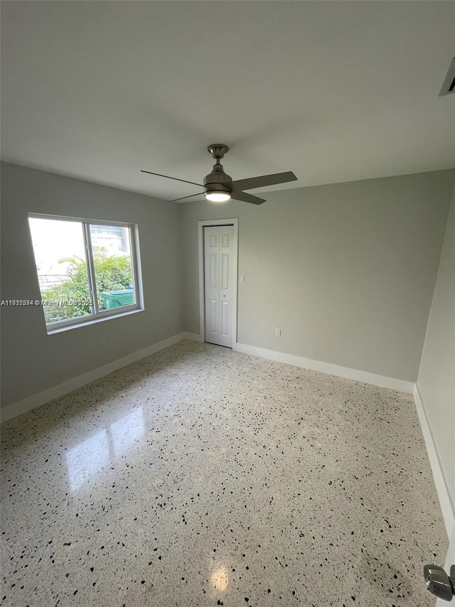 3518 Southwest 24th Terrace, Unit 3518 Miami, FL 33145 - Photo 9 of 11 an empty room with windows and ceiling fan