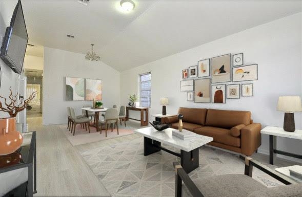a living room with furniture and a painting on the wall