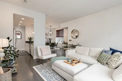 a living room with furniture rug and window