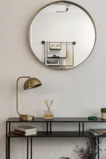 a kitchen with stainless steel appliances a dining table chairs refrigerator and sink