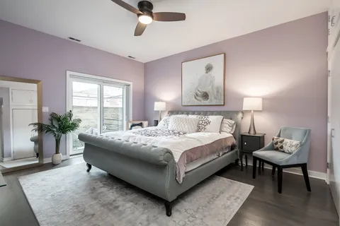 a bedroom with a bed and ceiling fan