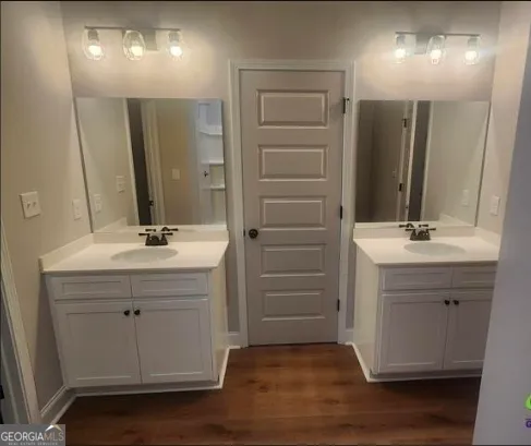 a bathroom with a sink vanity and mirror