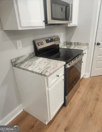 a kitchen with a sink stove and cabinets