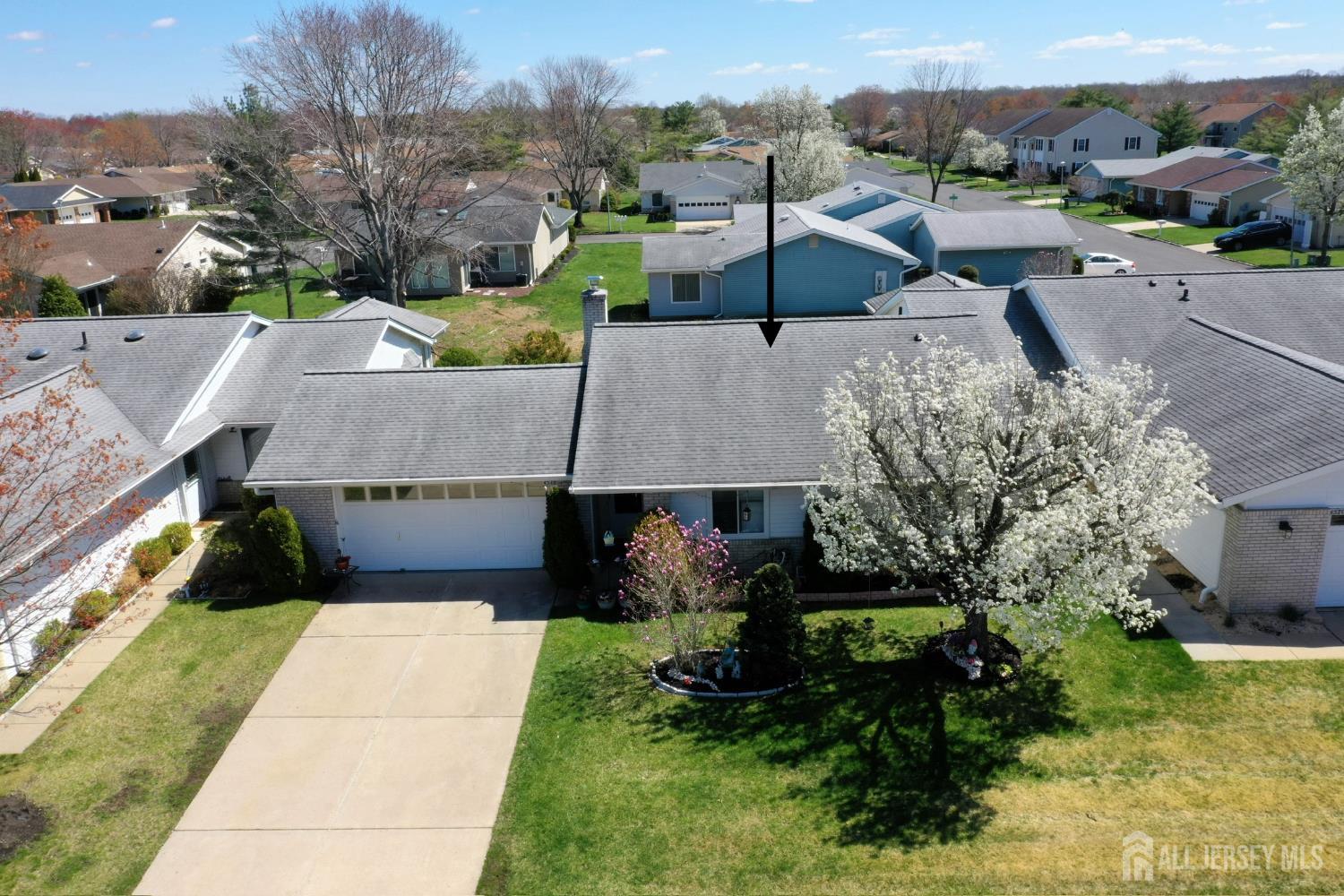 an aerial view of a house with garden space and street view