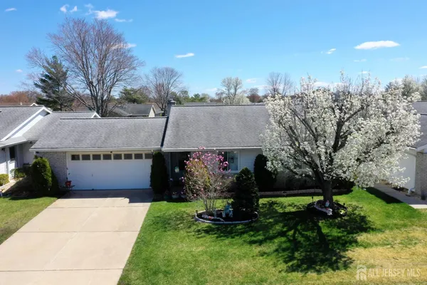 a front view of a house with a garden and plants
