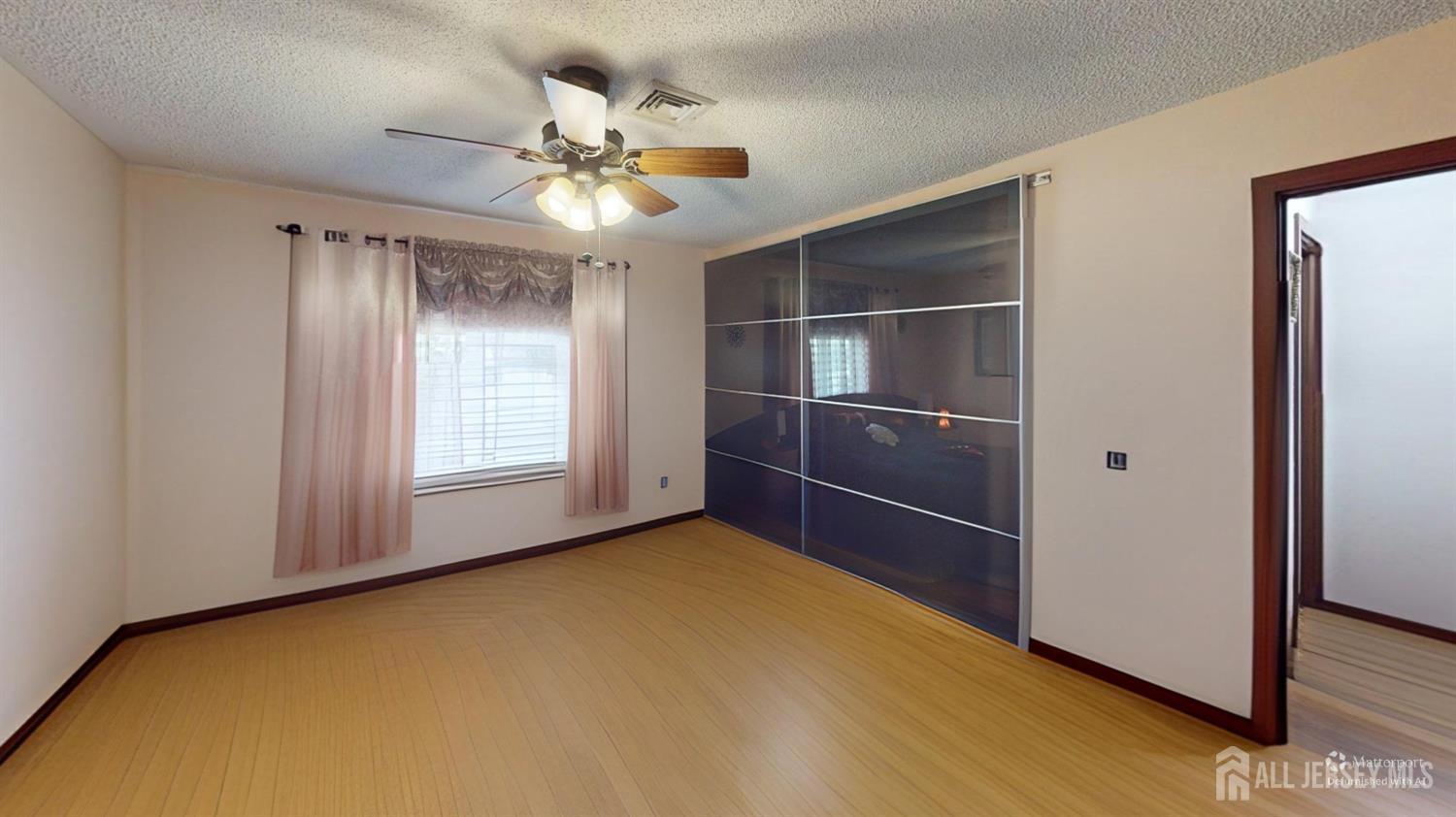 452A Closter Road, Unit B Monroe Township, NJ 08831 - Photo 27 of 46 a view of an empty room with a ceiling fan