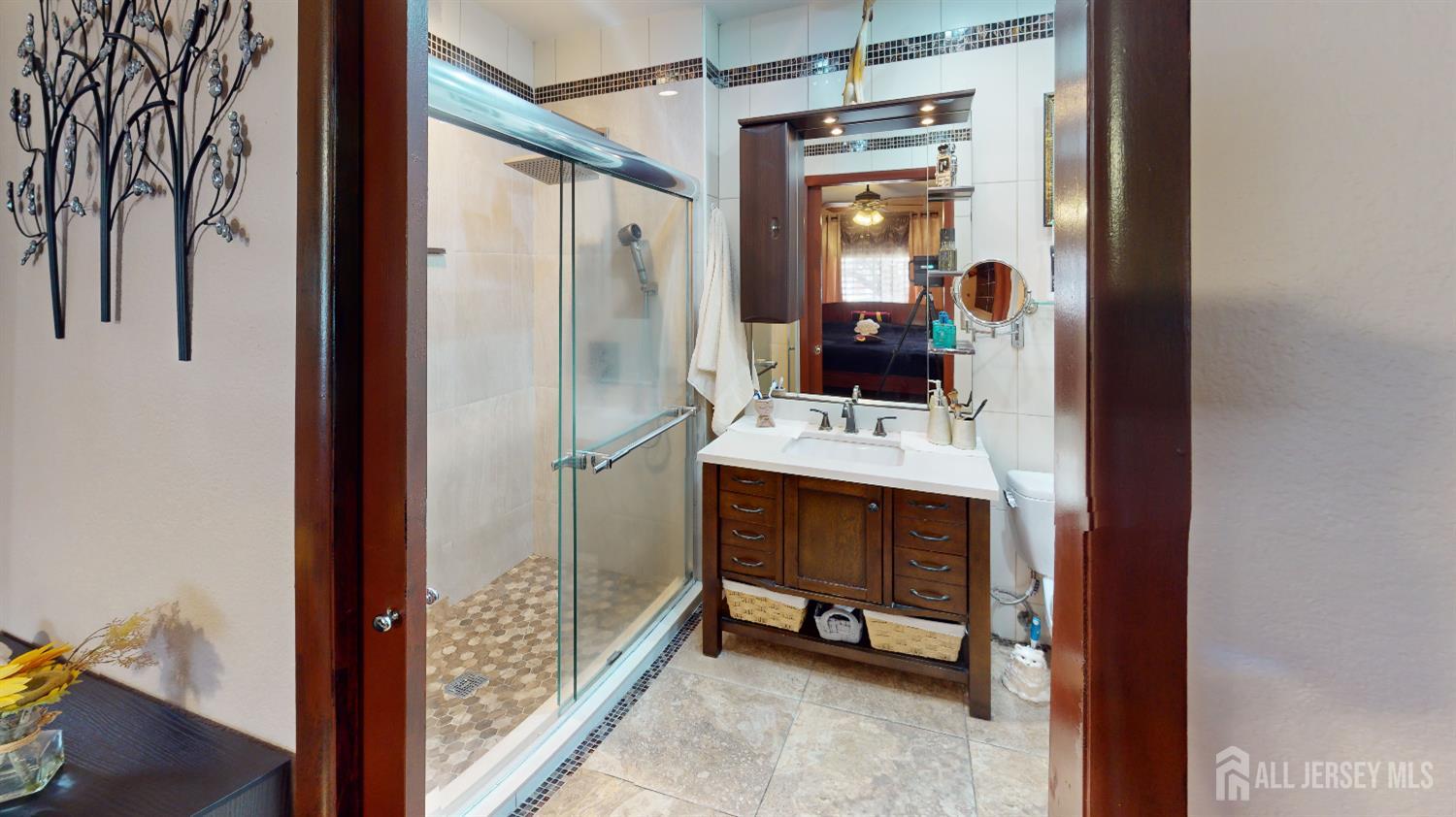 452A Closter Road, Unit B Monroe Township, NJ 08831 - Photo 28 of 46 a bathroom with a sink a mirror and a shower