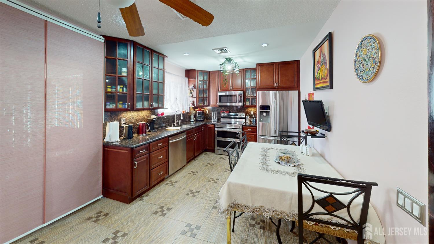452A Closter Road, Unit B Monroe Township, NJ 08831 - Photo 30 of 46 a kitchen with stainless steel appliances kitchen island granite countertop a stove and a refrigerator