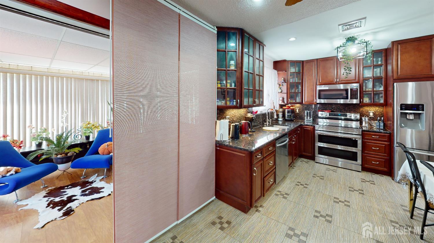 452A Closter Road, Unit B Monroe Township, NJ 08831 - Photo 31 of 46 a kitchen with stainless steel appliances kitchen island granite countertop a refrigerator and a stove top oven