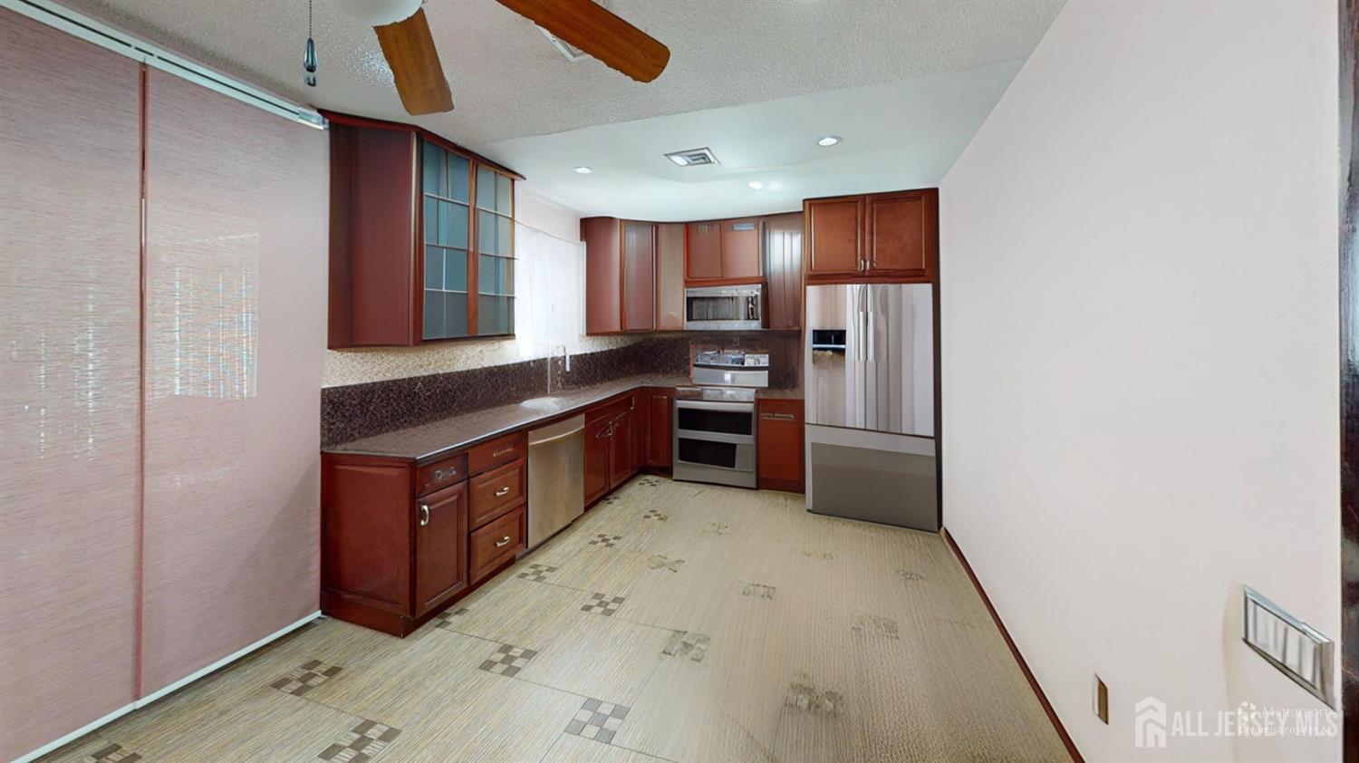 452A Closter Road, Unit B Monroe Township, NJ 08831 - Photo 32 of 46 a kitchen with stainless steel appliances a refrigerator and a stove