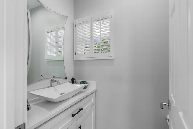 a bathroom with a sink and a window
