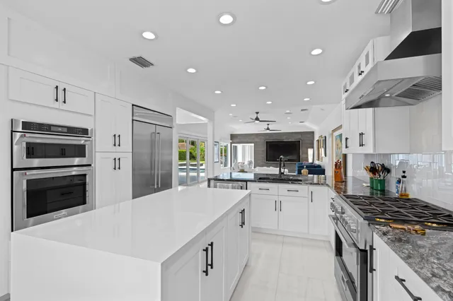 a kitchen with a stove a sink and a refrigerator