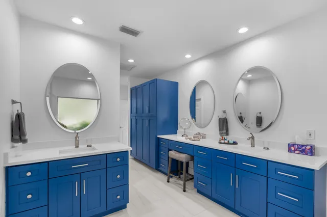 a bathroom with a double vanity sink and a mirror