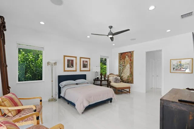 a spacious bedroom with a bed a couch and a window