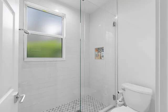 a bathroom with a shower and toilet