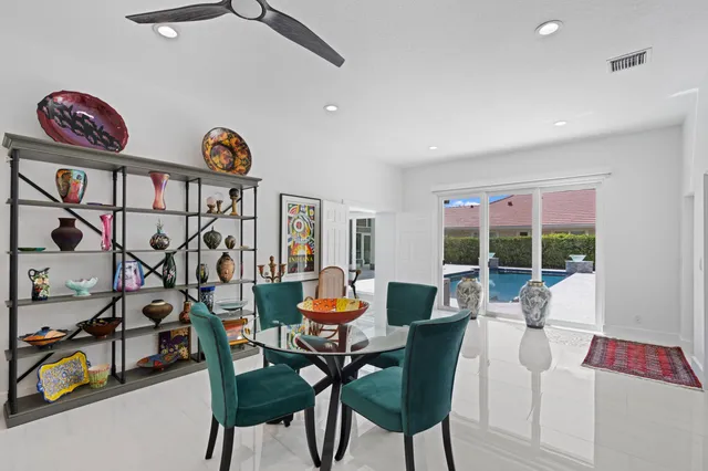 a dining room with furniture and a floor to ceiling window