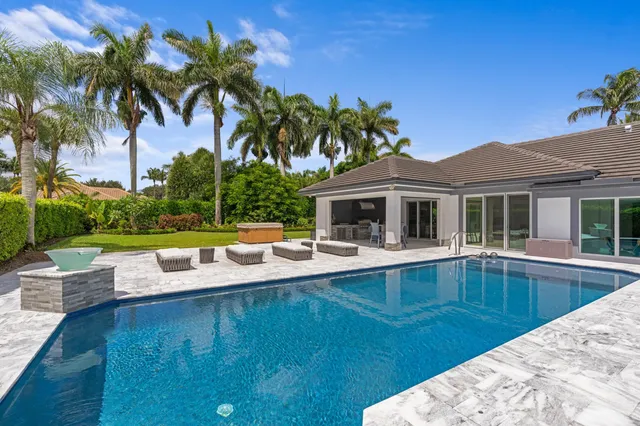a view of a house with swimming pool and sitting area