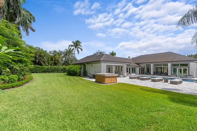 a view of a house with swimming pool and a yard