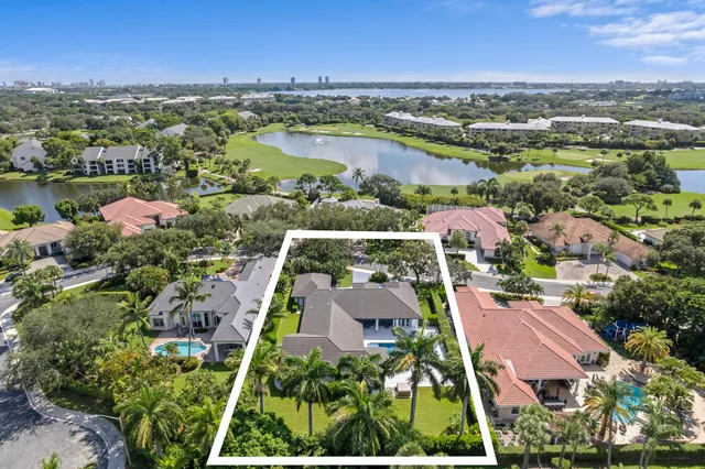 an aerial view of residential houses with outdoor space and river