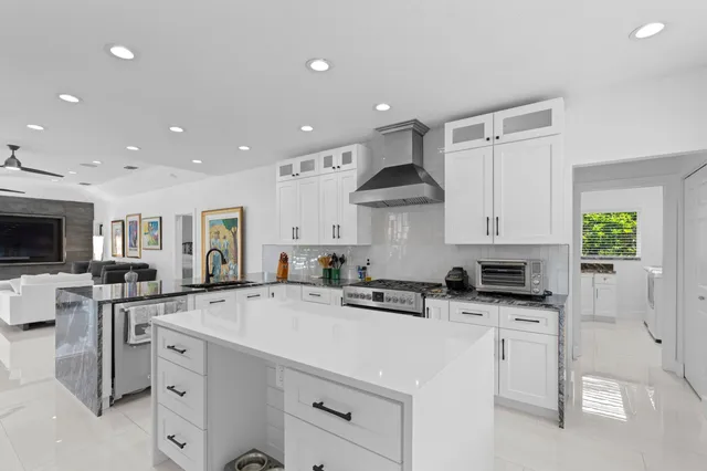 a kitchen with a sink a stove and cabinets