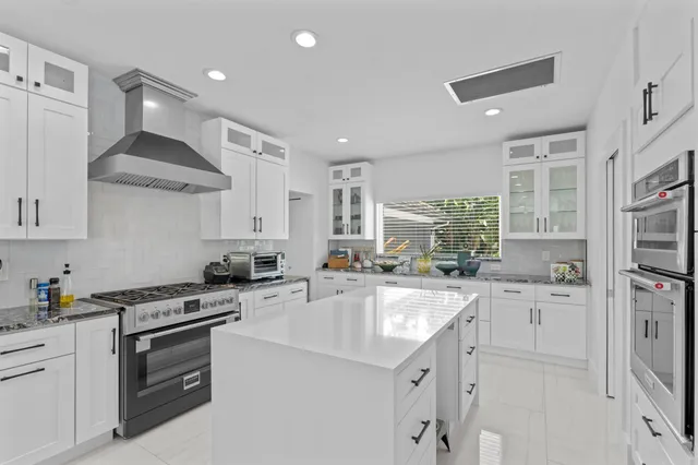 a kitchen with a sink stove and cabinets