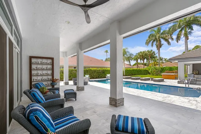 a living room with furniture and a floor to ceiling window