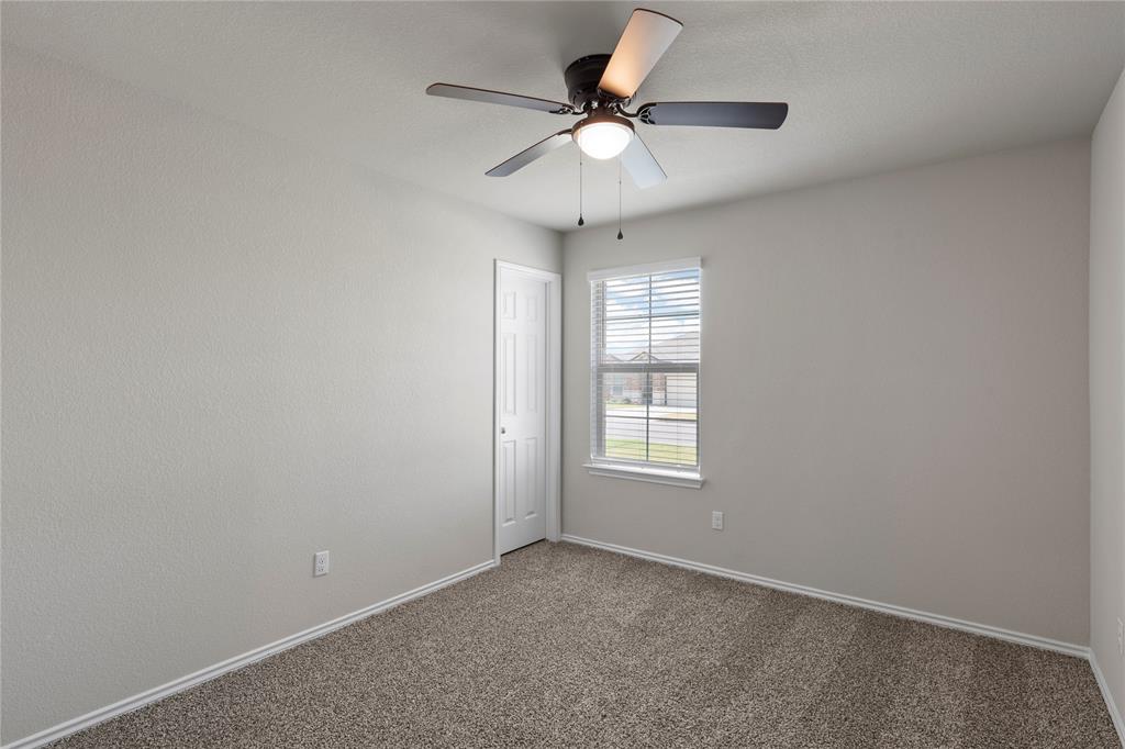 3012 Sherco Road Lorena, TX 76655 - Photo 11 of 14 an empty room with windows and ceiling fan