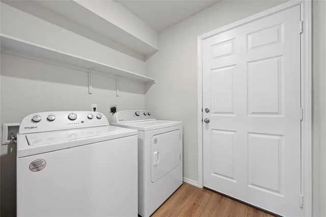 an empty room with windows and ceiling fan