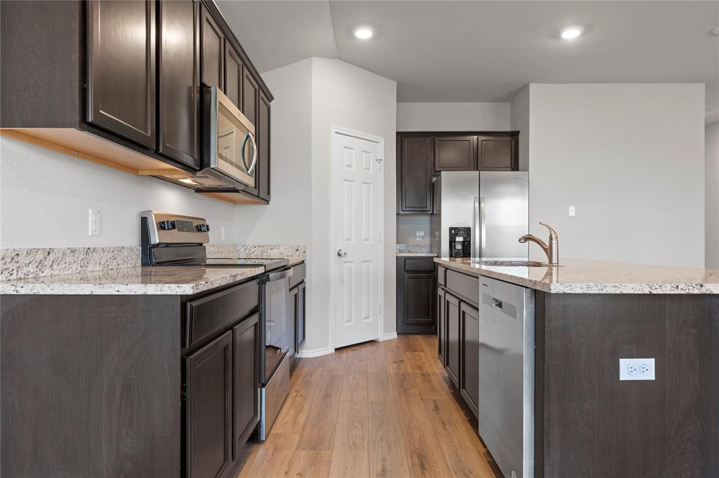 3012 Sherco Road Lorena, TX 76655 - Photo 5 of 14 a kitchen with stainless steel appliances granite countertop a refrigerator a stove and a sink