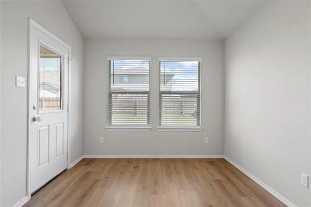 a kitchen with stainless steel appliances granite countertop a refrigerator a stove and a sink